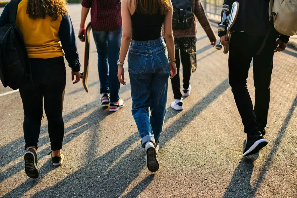 Group of teens influencing each other’s behavior