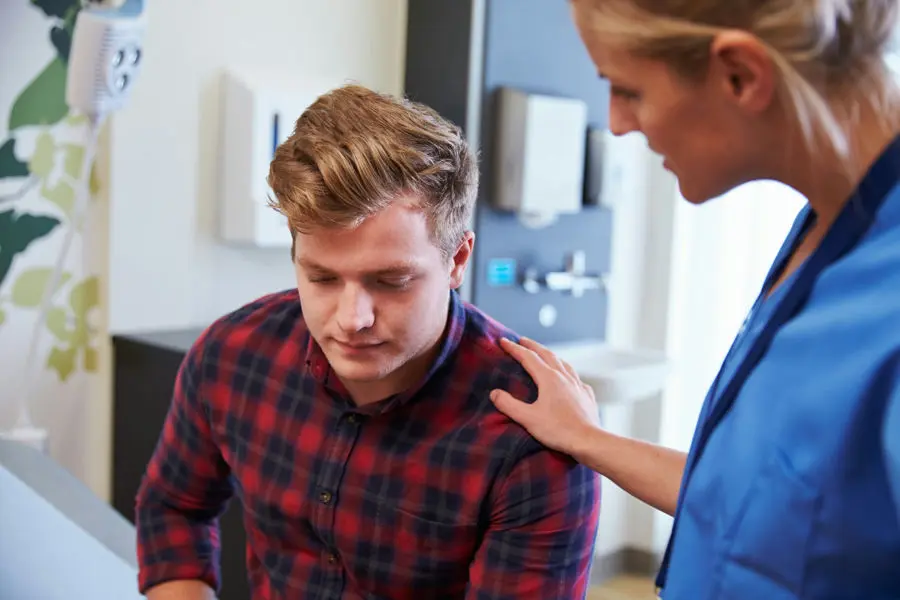 Patient discussing persistent stomach pain after drinking alcohol with a medical professional.