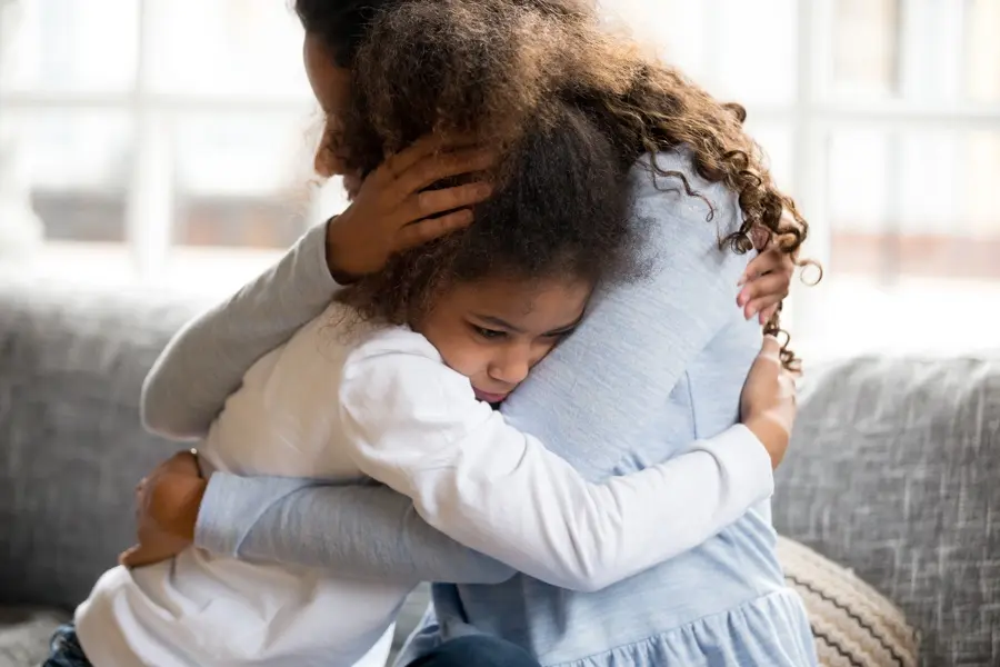 Mother embracing her child after recovery progress, symbolizing healing.