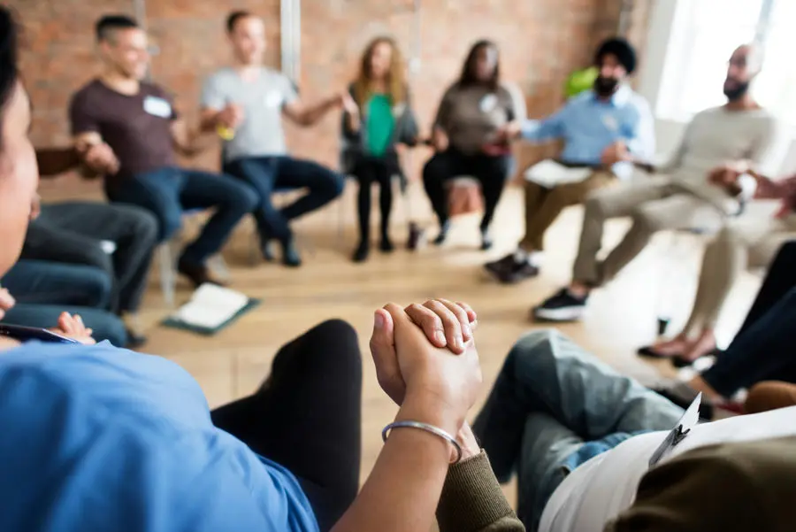 Group therapy session providing emotional support for individuals coping with cancer-related trauma.