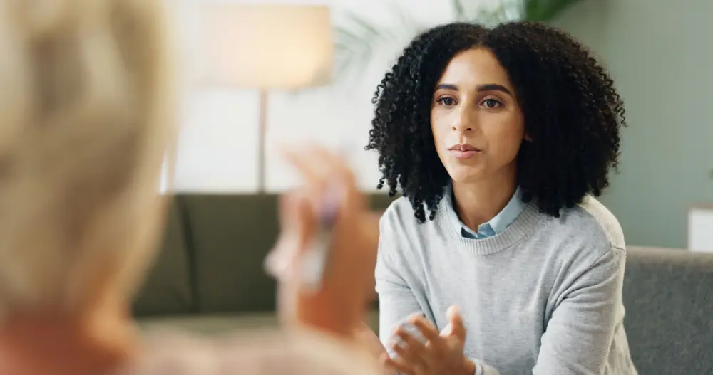 Therapist explaining addiction as a treatable medical condition during an individual counseling session
