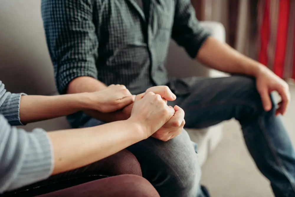 Family members having a supportive conversation about recovery from gambling addiction.