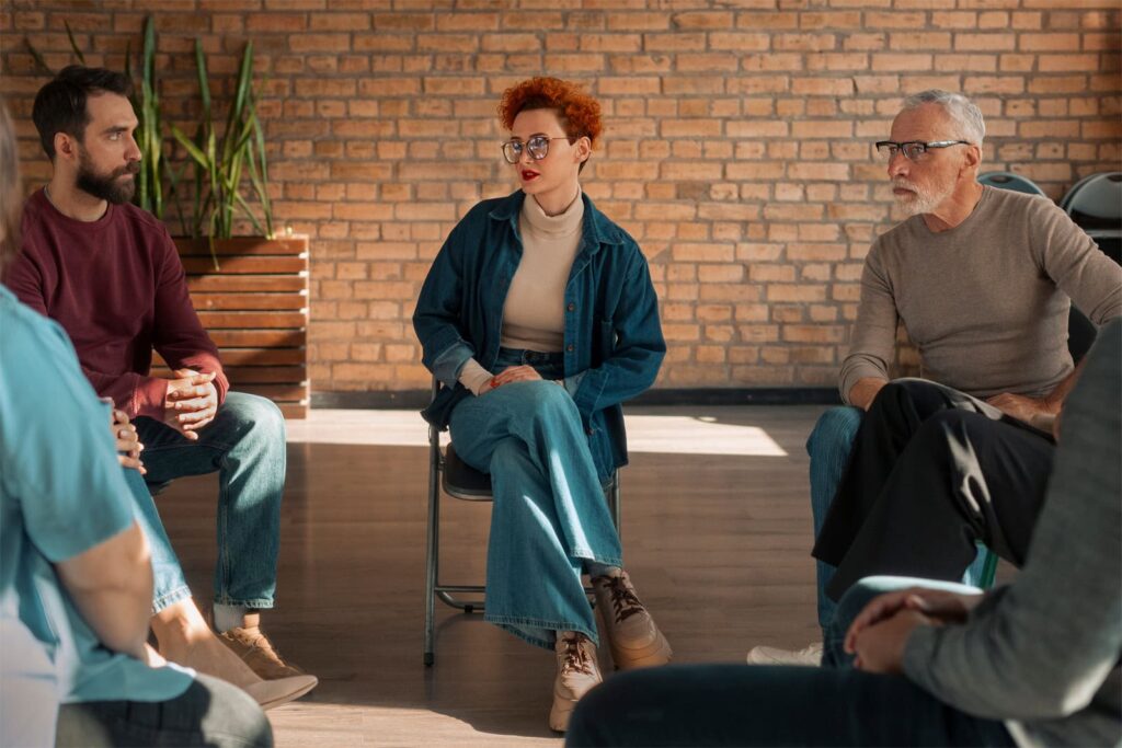 People in a group discussing purpose and connection in recovery.